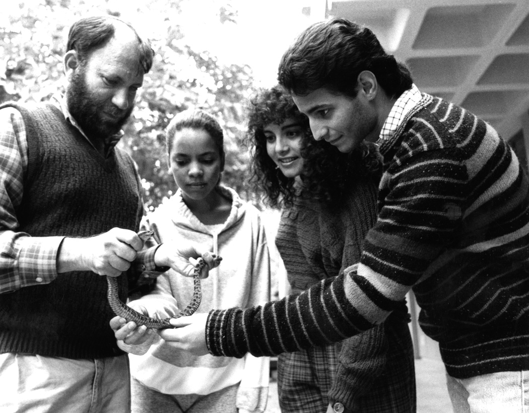 Professor David Morafka shows snake to students, ca 1990s